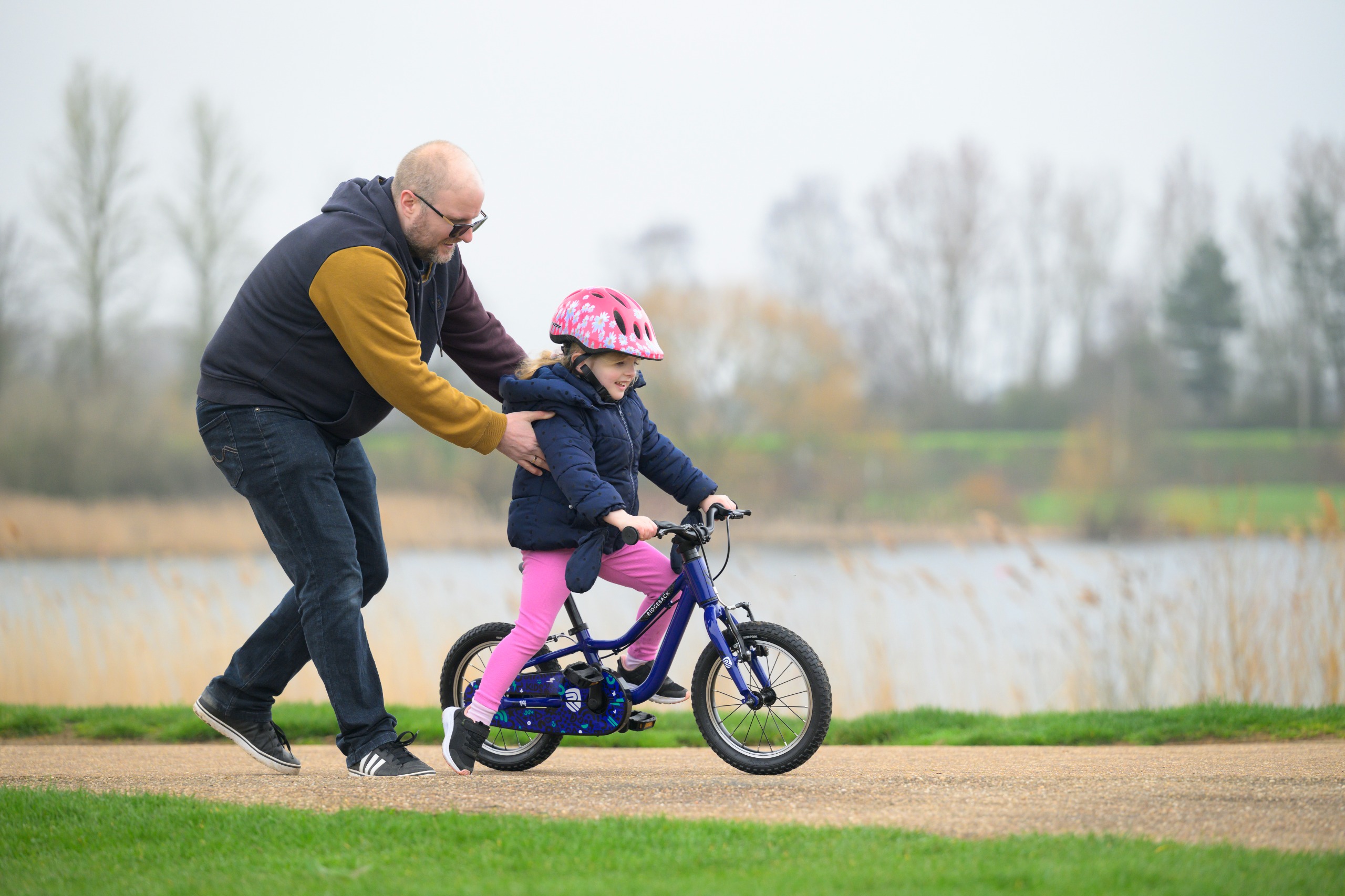 Man pushing a kids on a Ridgeback kids bike
